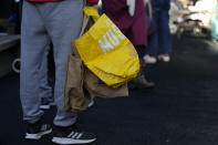 FILE - Customers queue with empty bags as they wait for the opening of the community food pantry in Vauxhall, London, Nov. 16, 2022. In his first month as Britain's prime minister, Rishi Sunak has stabilized the economy, reassured allies from Washington to Kyiv and even soothed the European Union after years of sparring between Britain and the bloc. But Sunak’s challenges are just beginning. He is facing a stagnating economy, a cost-of-living crisis – and a Conservative Party that is fractious and increasingly unpopular after 12 years in power. (AP Photo/Frank Augstein, File)