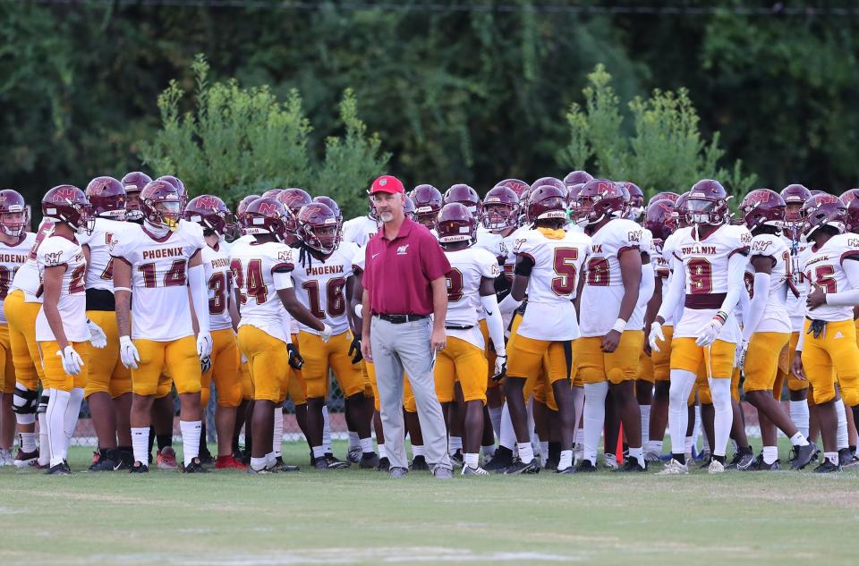 New Hampstead coach Kyle Hockman stands with the team before they take the field against Bradwell Institute on Friday, September 1, 2023 in Hinesville, Georgia.