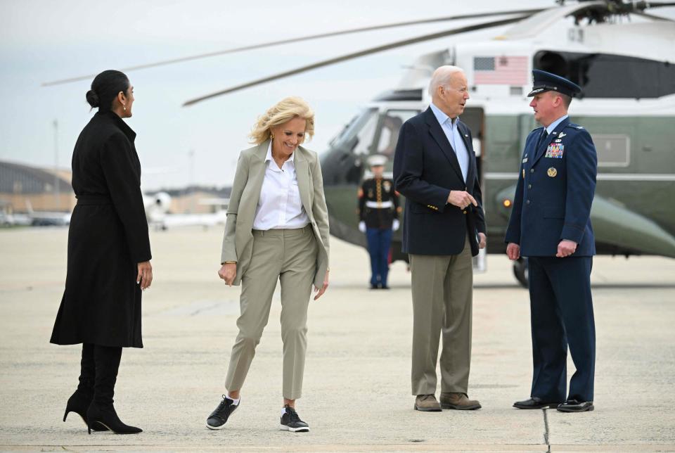 President Joe Biden, second from right, and First Lady Jill Biden, second from left, make their way to board Air Force One before departing from Joint Base Andrews in Maryland on March 31, 2023.