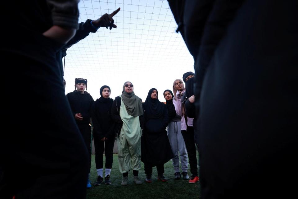 Team members huddle during a Sisterhood training session (Reuters)