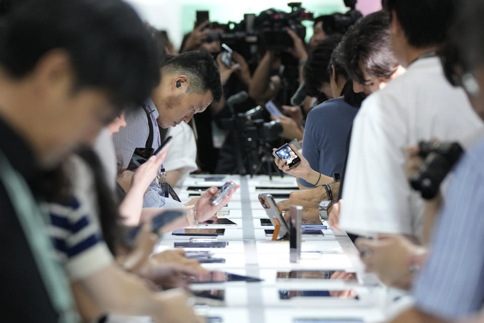 People look at products during the Galaxy Unpacked 2023 event at the COEX in Seoul, South Korea, Wednesday, July 26, 2023. Samsung Electronics on Wednesday unveiled two foldable smartphones as it continues to bet on devices with bending screens, a budding market that has yet to fully take off because of high prices. (AP Photo/Ahn Young-joon)