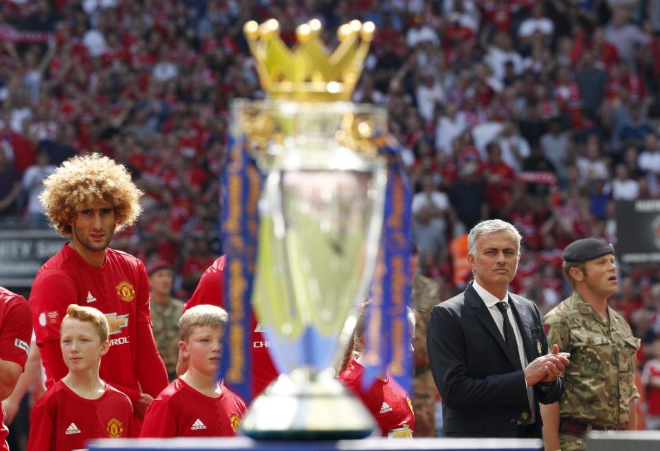 Football Soccer Britain - Leicester City v Manchester United - FA Community Shield - Wembley Stadium - 7/8/16 Manchester United manager Jose Mourinho and Marouane Fellaini line up with the Premier League trophy before the match Action Images via Reuters / John Sibley Livepic EDITORIAL USE ONLY. No use with unauthorized audio, video, data, fixture lists, club/league logos or "live" services. Online in-match use limited to 45 images, no video emulation. No use in betting, games or single club/league/player publications. Please contact your account representative for further details.