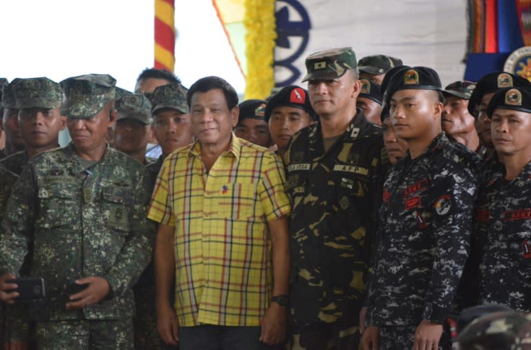 Philippine President Rodrigo Duterte (centre L) ended a ceasefire after a rebel ambush