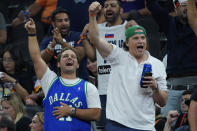 Dallas Mavericks fans cheer during the second half of Game 7 of an NBA basketball Western Conference playoff semifinal against the Phoenix Suns, Sunday, May 15, 2022, in Phoenix. The Mavericks defeated the Suns 123-90. (AP Photo/Matt York)