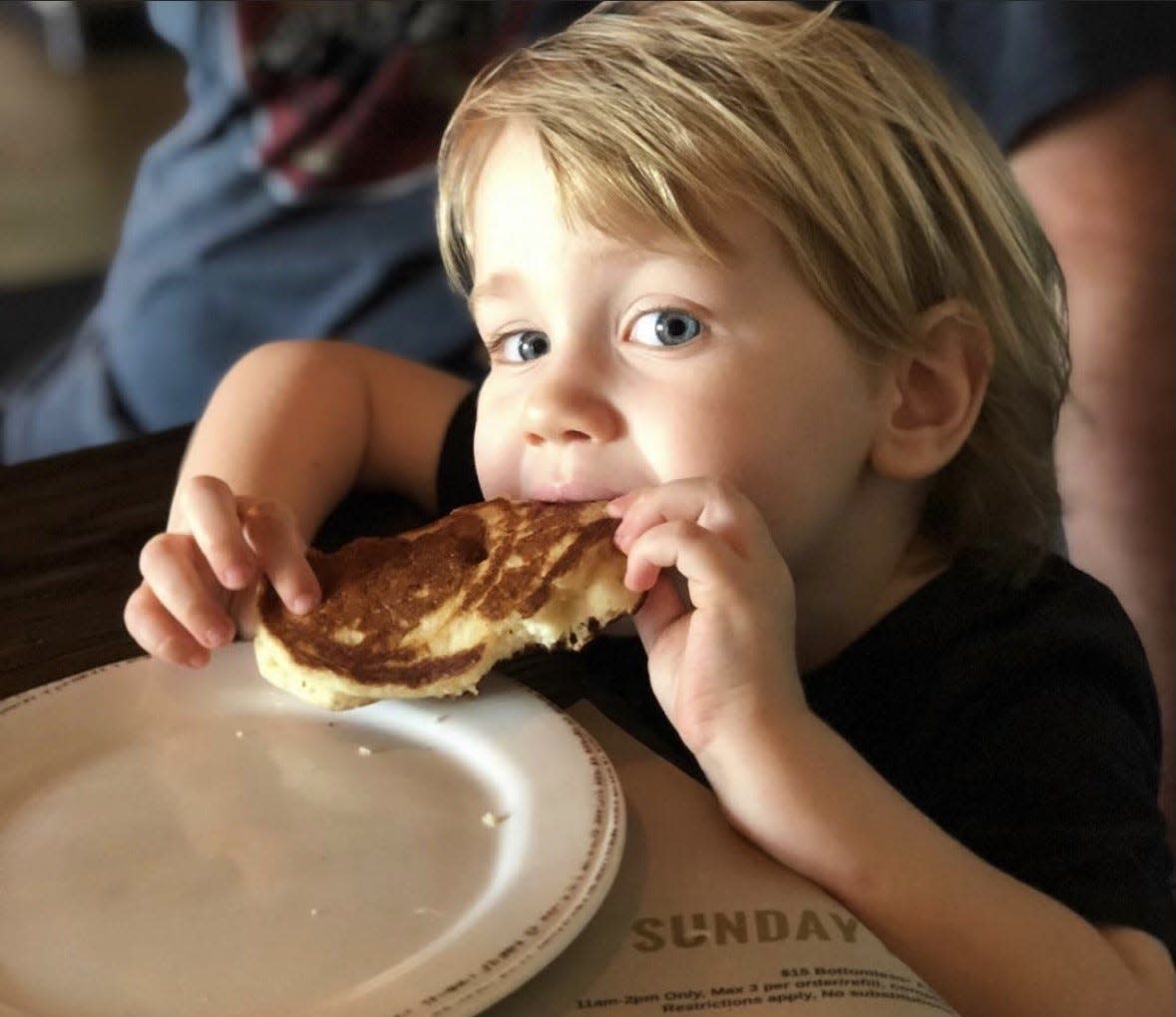 Chef David Schroeder's son David enjoys a pancake during brunch at Brick & Barrel restaurant in Abacoa, Jupiter.