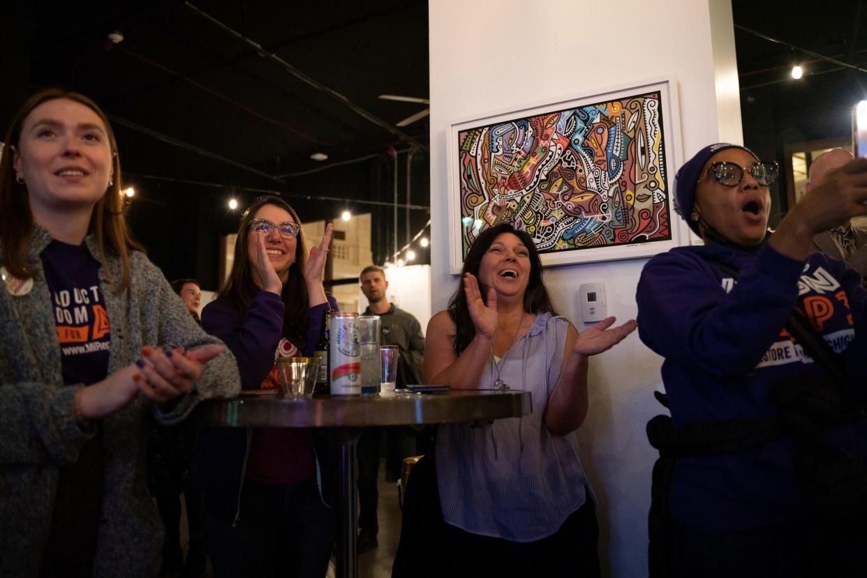 Taylor Belyea, 22, of Shelby Township, left, Sarah Miller Schrage 36, of Grosse Pointe Park, Lisa DeBlasi, 52, of Clinton Township, and Tamara Lopes, 44, of Southfield, applaud during a Yes on Proposal 3 campaign watch party at the David Whitney Building in downtown Detroit on Tuesday, Nov. 8, 2022. Voters approved the measure to enshrine abortion rights in the Michigan Constitution.