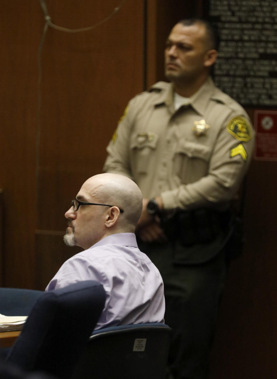 FILE - In this May 29, 2019, file photo, Michael Gargiulo, sitting, listens to the testimony of Ashton Kutcher during Gargiulo's murder trial at Los Angeles Superior Court. Gargiulo has pleaded not guilty to two counts of murder and an attempted-murder charge stemming from attacks in the Los Angeles area between 2001 and 2008, including the death of Kutcher's former girlfriend, 22-year-old Ashley Ellerin. (Genaro Molina/Los Angeles Times via AP, Pool, File)