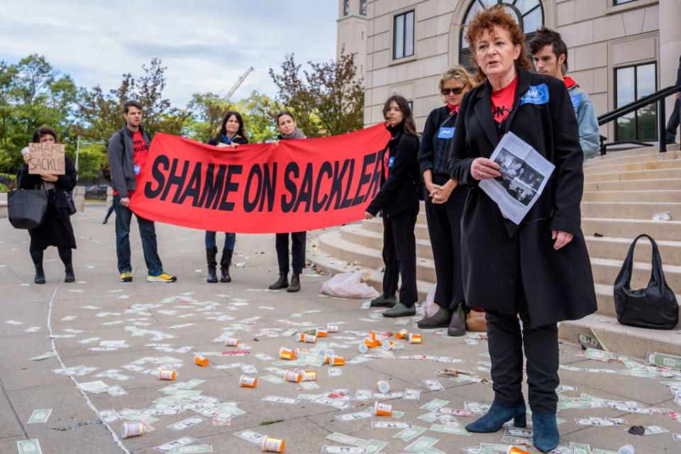 Nan Goldin and members of P.A.I.N. and Truth Pharm at a rally and die-in outside New York's Southern District Federal Court in White Plains, where Purdue Pharmaceuticals bankruptcy hearing was being held, on Oct. 10, 2019<span class="copyright">Erik McGregor/LightRocket via Getty Images</span>