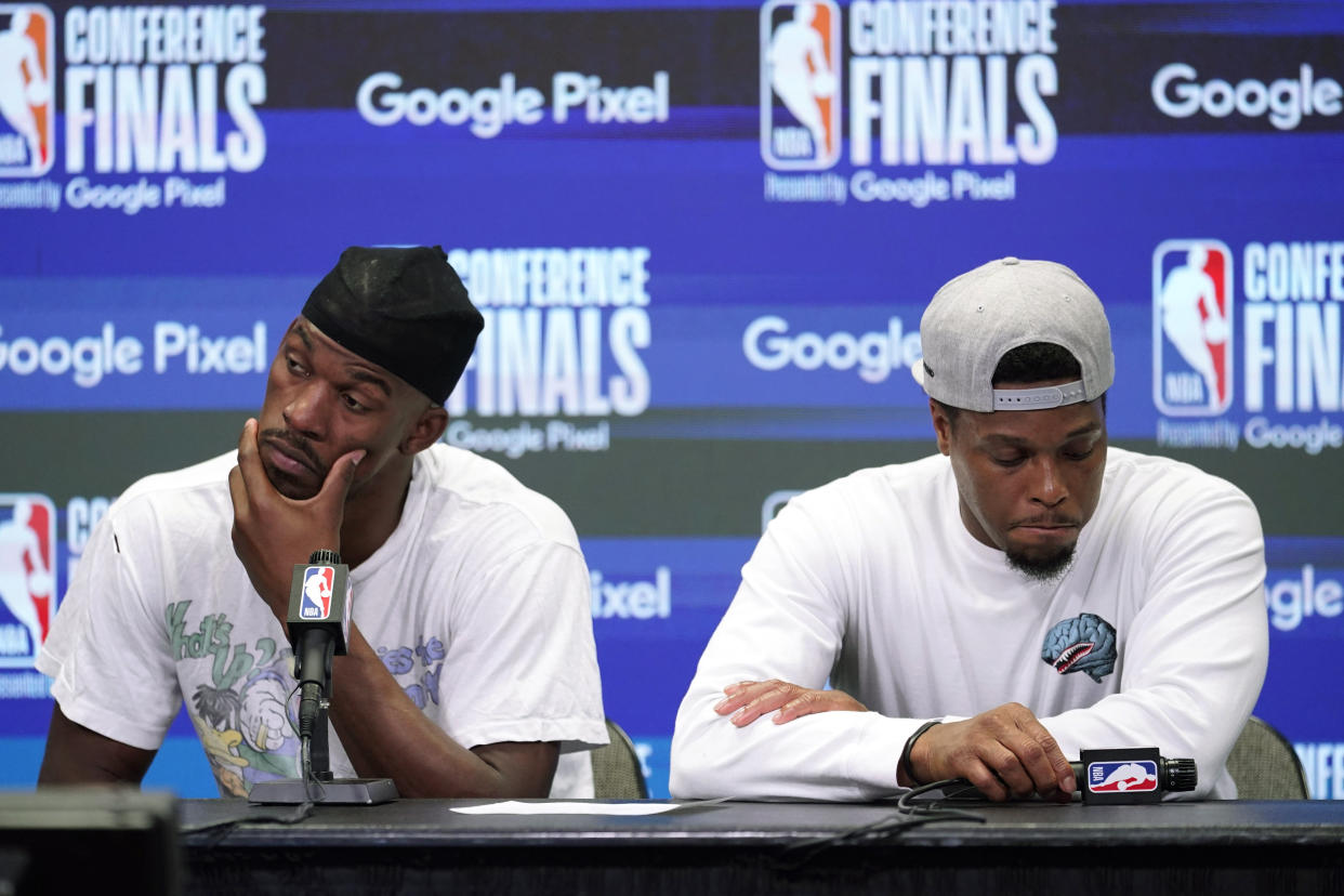 Miami Heat forward Jimmy Butler and Miami Heat guard Kyle Lowry (7) gesture during a post- game news conference after Game 5 of the NBA basketball Eastern Conference finals playoff series against the Boston Celtics, Wednesday, May 25, 2022, in Miami. (AP Photo/Lynne Sladky)