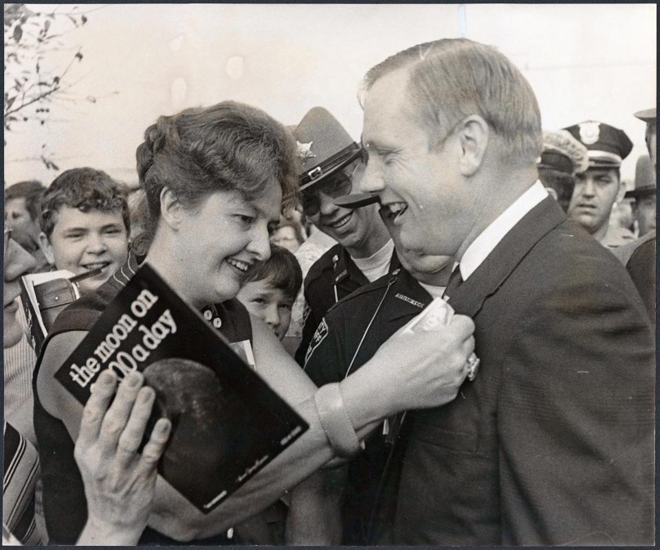 Neil Armstrong at his Wapakoneta homecoming on September 6, 1969, where a former classmate, Columbus resident Kathryn Dunnavant, pins on his name tag.