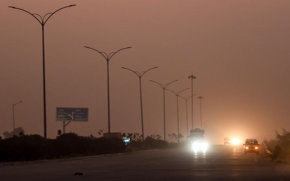 Commuters drive under smog conditions in Sonipat in Delhis neighbouring Haryana state  - AFP