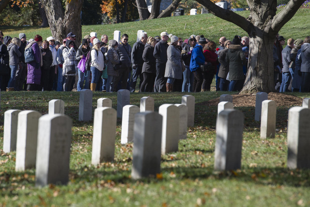 People stand in line to enter the Arlington National Cemetery Amphitheater for the National Veterans Day Observance on Sunday. (Photo: Cliff Owen/AP)