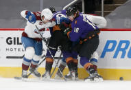 Colorado Avalanche's Logan O'Connor, left, battles with Arizona Coyotes' Clayton Keller, middle, and Christian Dvorak during the first period of an NHL hockey game Saturday, Feb. 27, 2021, in Glendale, Ariz. (AP Photo/Darryl Webb)