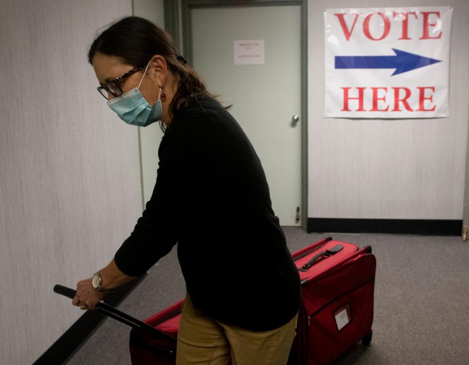 Early in-person voting at the Portage County Board of Elections in Ravenna. Deb Defer, a poll worker, transports voting materials where they will be picked up and taken to different precincts in the county for election day on November 3.