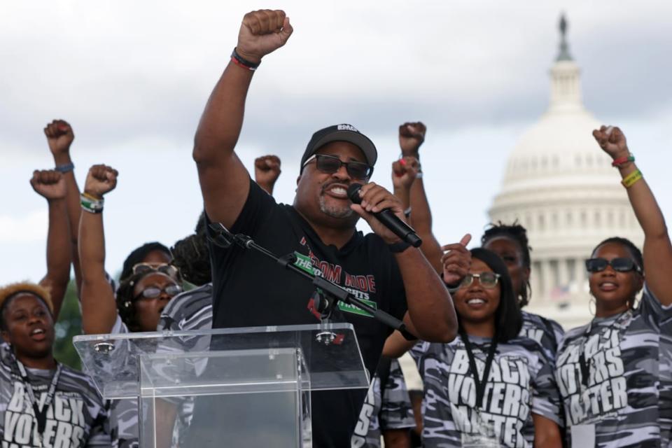 WASHINGTON, DC – JUNE 26: Co-founder and Executive Director of Black Voters Matter Cliff Albright speaks as other voting rights activists hold up fists during a “Rally for D.C. Statehood,” the last stop of BVM’s “Freedom Ride for Voting Rights” bus tour, at the National Mall June 26, 2021 in Washington, DC. (Photo by Alex Wong/Getty Images)