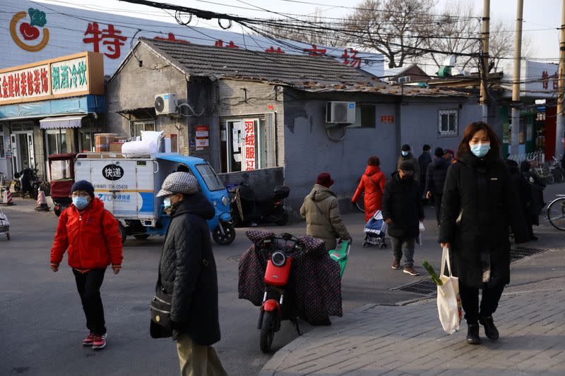 People walk on a street, as COVID-19 pandemic continues in the country, in Beijing