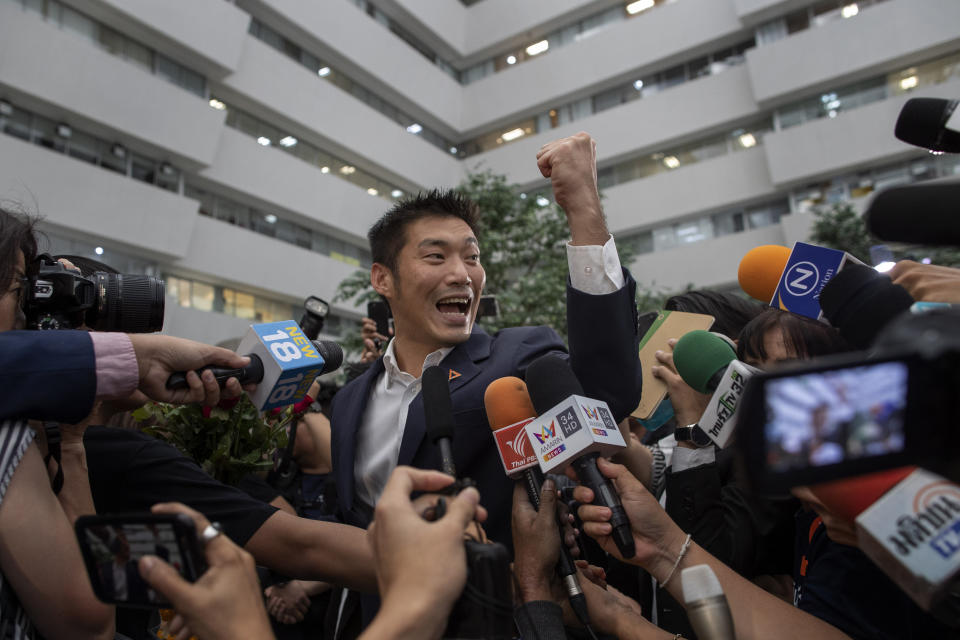 Thanathorn Juangroongruangkit, center, leader of the anti-military Future Forward Party gestures as he arrive at Constitutional Court in Bangkok, Thailand, Wednesday, Nov. 20, 2019. Thanathorn is expected to receive a verdict whether he is eligible to remain as a member of the parliament due to an accusation of owning media shares a violation of the Thai constitution. (AP Photo/Gemunu Amarasinghe)