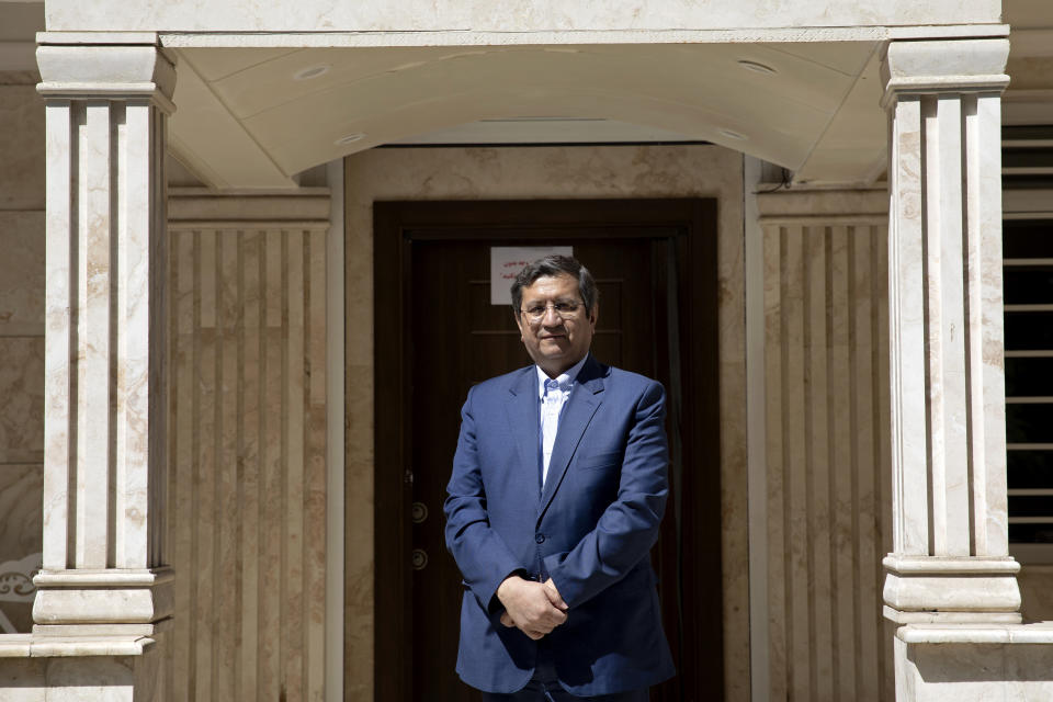 Former Iranian Central Bank chief Abdolnasser Hemmati, a candidate in Iran's upcoming presidential election, poses for a photo at his office in Tehran, Iran, Wednesday, June 9, 2021. Hemmati said Wednesday he'd be willing to meet with U.S. President Joe Biden if he wins his country's election next week, though "America needs to send better and stronger signals" to the Islamic Republic. (AP Photo/Ebrahim Noroozi)