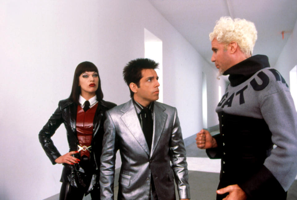 Milla Jokovich, Ben Stiller, and Will Ferrell stand in a hallway