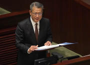 Hong Kong's Financial Secretary Paul Chan delivers his annual budget speech at the Legislative Council in Hong Kong Wednesday, Feb. 26, 2020. Hong Kong's government is proposing a nearly $1,300 cash handout for each resident over 18 years old to help alleviate hardships brought on by the spreading viral outbreak and prolonged political protests.(AP Photo/Vincent Yu)