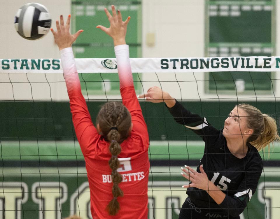 Central Catholic's Emma Borquin hits a kill shot over Aleyse Siefert of Buckeye Central in their regional final win over Buckeye Central Nov. 4, 2023.