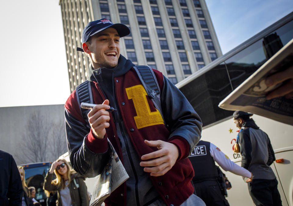 Loyola guard Clayton Custer signs autographs as fans welcome the Ramblers back to campus after the team advanced to the Sweet 16 of the NCAA tournament. (Getty)