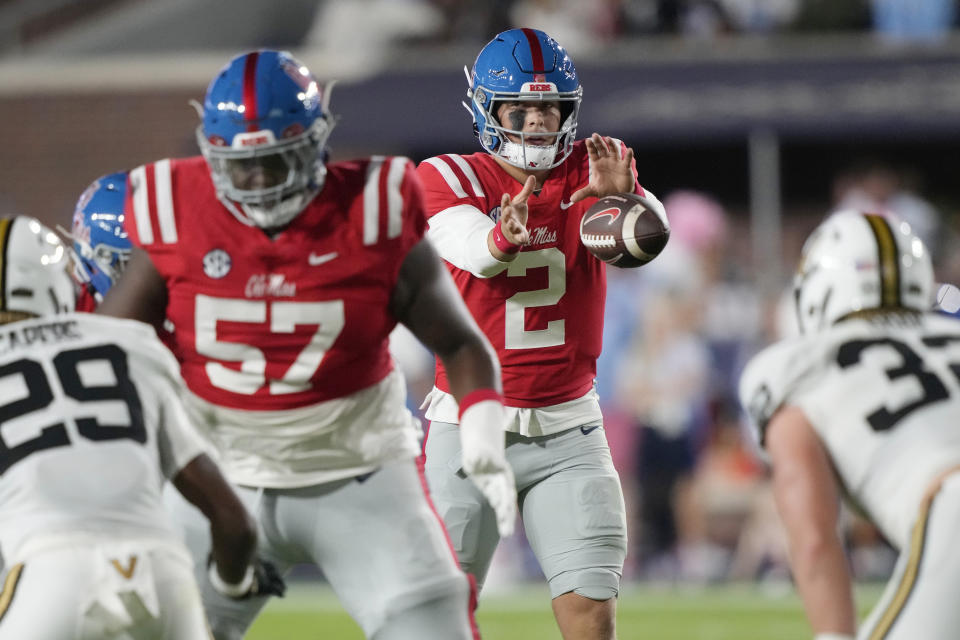 Mississippi quarterback Jaxson Dart (2) takes a snap while offensive lineman Micah Pettus (57) sets up to block Vanderbilt defensive back Miles Capers (29) during the first half of an NCAA college football game in Oxford, Miss., Saturday, Oct. 28, 2023. (AP Photo/Rogelio V. Solis)