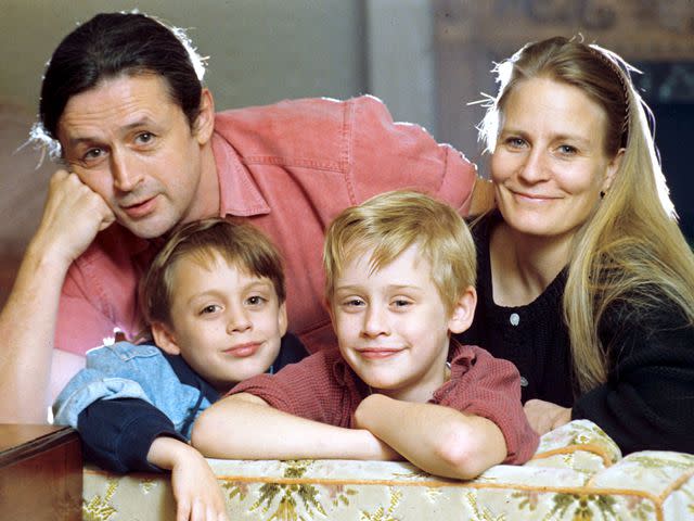 <p>News UK Ltd/Shutterstock </p> Macaulay and Kieran Culkin with their parents, Kit and Patricia, at home in 1990.