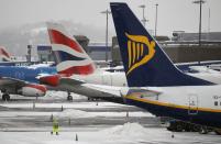 Workers clean snow from a runway at Edinburgh Airport in Edinburgh, Scotland. Edinburgh Airport has been named among the top child-friendly airports in the world by Conde Nast Traveller India magazine.