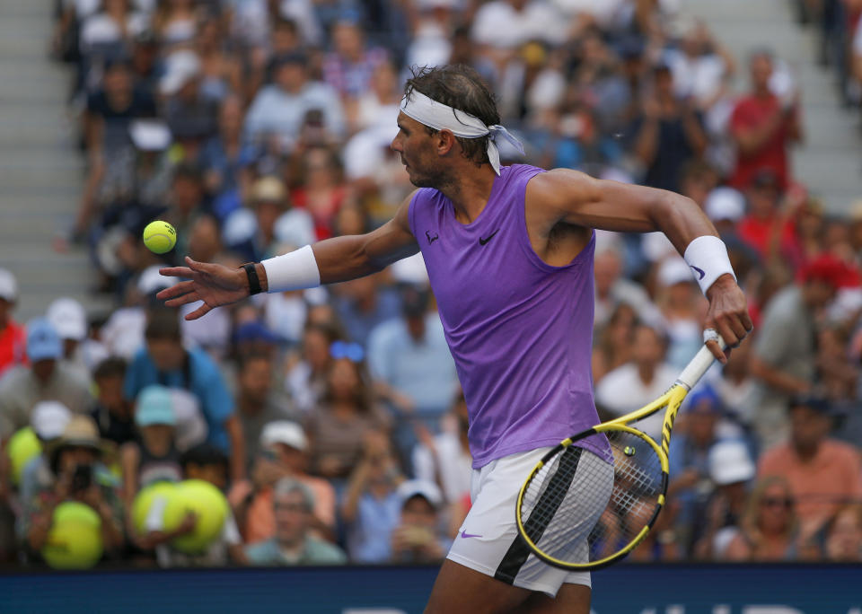 Rafael Nadal, of Spain, hits autographed balls into the grandstand after defeating Hyeon Chung, of South Korea, during round three of the US Open tennis championships Saturday, Aug. 31, 2019, in New York. (AP Photo/Eduardo Munoz Alvarez)