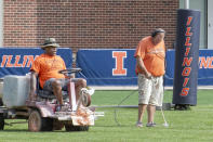 University of Illinois athletic facility attendants Tyrone Washington, left, and Shawn Hannan, right, renew the line markers of the schools football practice field in Champaign, Ill., Wednesday, Sept. 16, 2020. Less than five weeks after pushing fall sports to spring in the name of player safety during the pandemic, the Big Ten conference changed course Wednesday and said it plans to open its football season the weekend of Oct. 23-24. (Robin Scholz/The News-Gazette via AP)