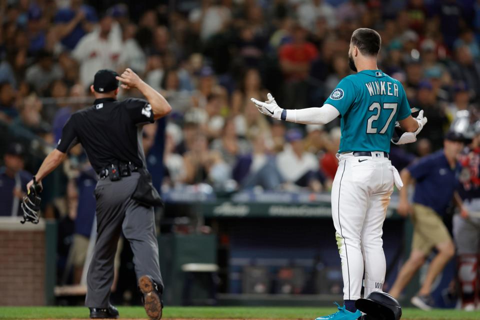 Home plate umpire Dan Merzel throws out Seattle's Jesse Winker after arguing a strike out call during a game against Cleveland last season.