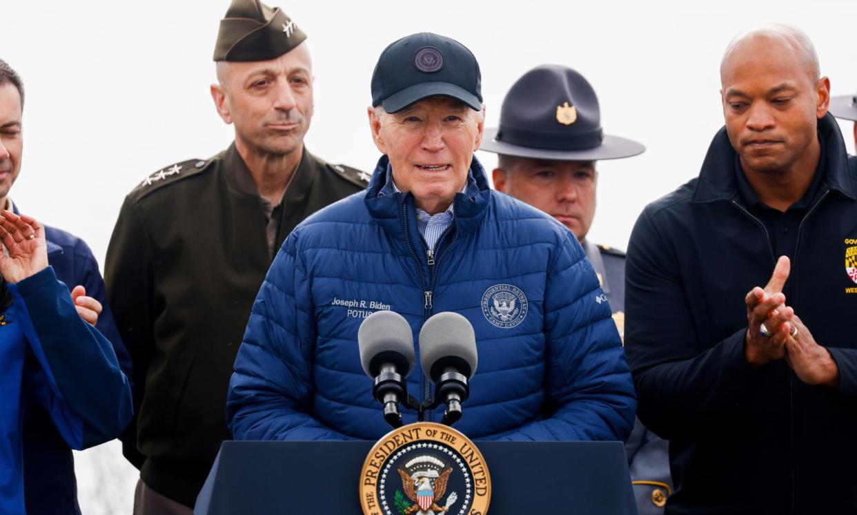 <span>President Biden speaks alongside Maryland governor Wes Moore (right, clapping), on 5 April 2024 in Dundalk, Maryland.</span><span>Photograph: Julia Nikhinson/AP</span>