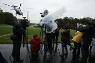 <p>Members of the White House press corps cover a Marine One departure, with President Donald Trump and first lady Melania Trump aboard, from the White House Aug. 29, 2017 in Washington. (Photo: Alex Wong/Getty Images) </p>