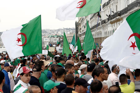 Demonstrators carry national flags during a protest to demand the postponement of a presidential election and the removal of the ruling elite in Algiers, Algeria May 24, 2019. REUTERS/Ramzi Boudina