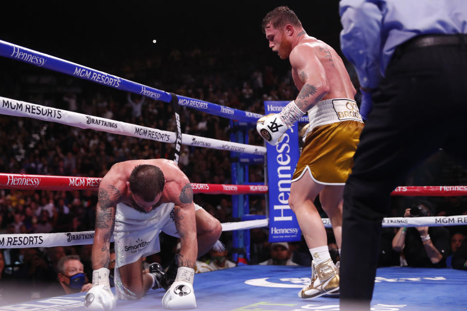 Canelo Alvarez, of Mexico, knocks down Caleb Plant during a super middleweight title unification fight Saturday, Nov. 6, 2021, in Las Vegas. (AP Photo/Steve Marcus)