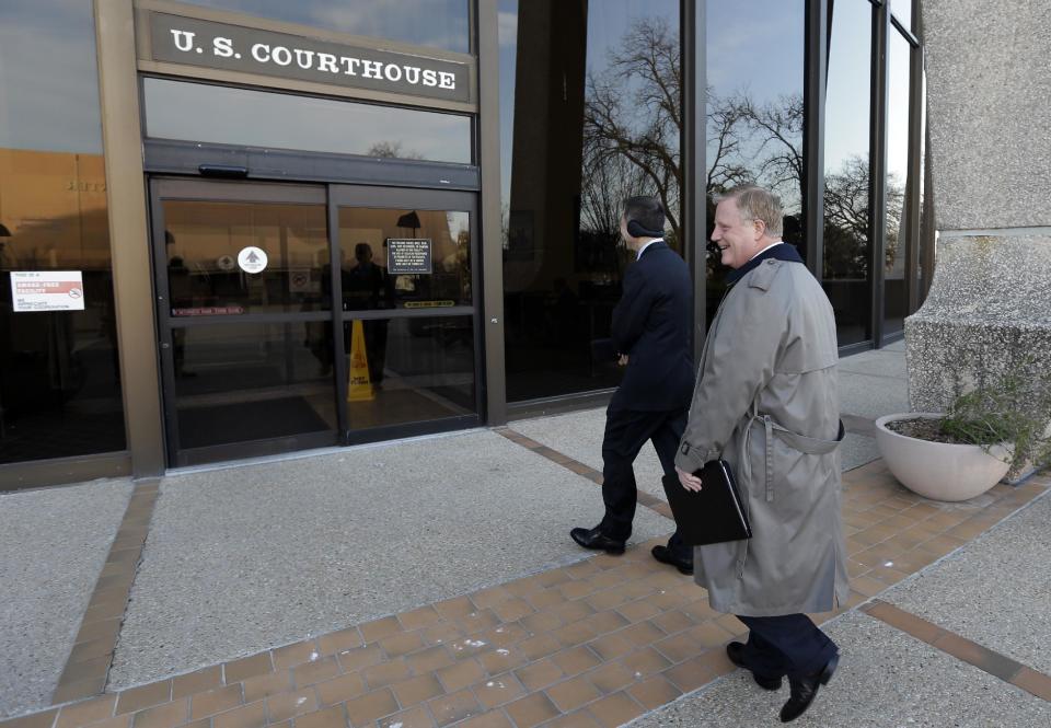 Victor Holmes, left, and partner Mark Phariss, right, arrive at the U.S. Federal Courthouse, Wednesday, Feb. 12, 2014, in San Antonio, where a federal judge is expected to hear arguments in a lawsuit challenging Texas' ban on same-sex marriage. (AP Photo/Eric Gay)