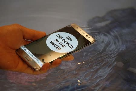 A model demonstrates waterproof function of Galaxy Note 7 new smartphone during its launching ceremony in Seoul, South Korea, August 11, 2016. REUTERS/Kim Hong-Ji/Files