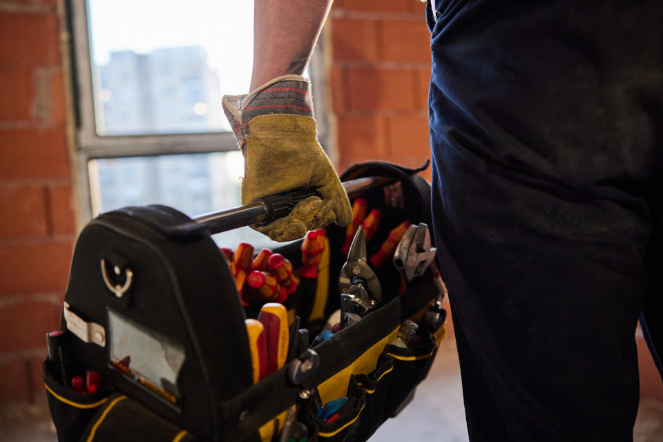 A person is holding a toolbox