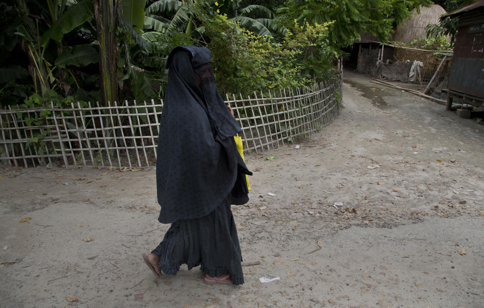 In this Aug. 31, 2019 photo, a Muslim woman walks with documents to check her name in the final list of National Register of Citizens in Morigaon district, Assam, India. About 1.9 million people were left out of the National Register of Citizens _ a mammoth exercise to weed out illegal mainly Bangladeshi immigrants from Assam’s more than 32 million people. (AP Photo/Anupam Nath)