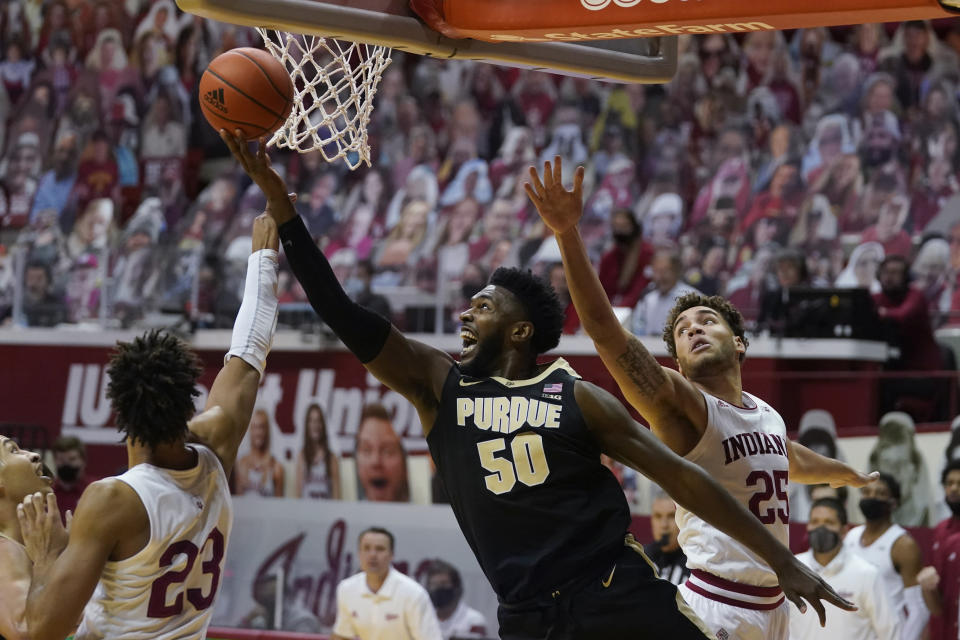 Purdue's Trevion Williams (50) shoots against Indiana's Trayce Jackson-Davis (23) and Race Thompson (25) during the first half of an NCAA college basketball game Thursday, Jan. 14, 2021, in Bloomington, Ind. (AP Photo/Darron Cummings)