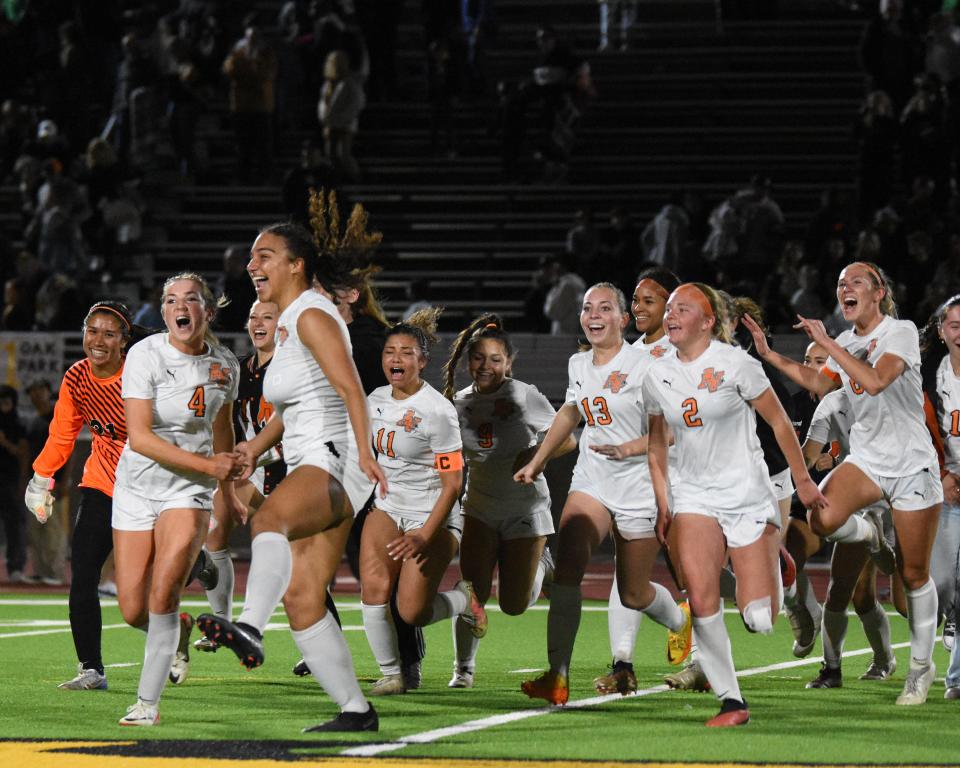 Apple Valley runs back to the sideline in celebration after beating Oak Park on Friday, Feb. 24, 2024. Apple Valley defeated Oak Park 2-1 to capture the CIF-Southern Section Division 3 championship.