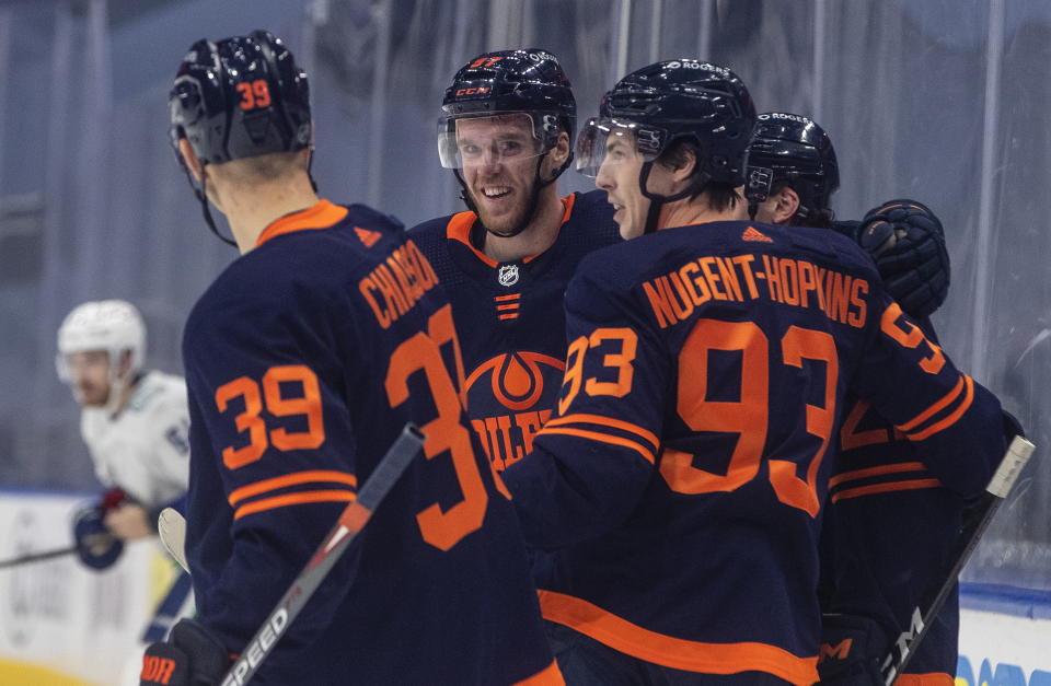 Edmonton Oilers' Connor McDavid (97) celebrates a goal against the Vancouver Canucks during the second period of an NHL hockey game Thursday, Jan. 14, 2021, in Edmonton, Alberta. (Jason Franson/The Canadian Press via AP)