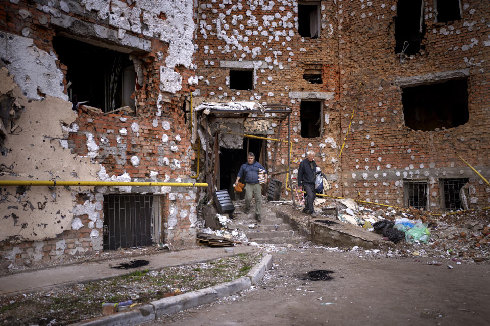 Oleksiy Onoschenko, 42, rescues books from his house destroyed during the Russian occupation in Irpin, in the outskirt of Kyiv, Ukraine on Saturday, April 30, 2022. (AP Photo/Emilio Morenatti)