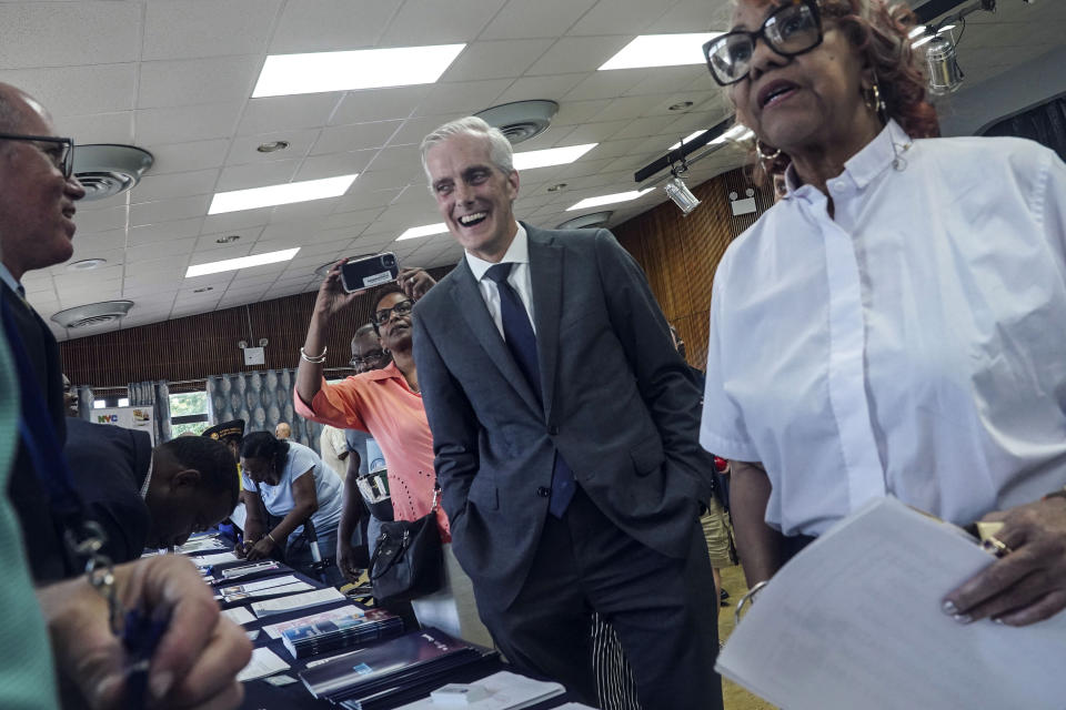 Veterans Affairs Secretary Denis McDonough, center, meets with attendees at a resource fair for veterans and survivors to apply for benefits under the PACT Act, Wednesday Aug. 2, 2023, in New York. Last year Congress delivered the Pact Act to expand VA healthcare and benefits for more than five million veterans and their families. (AP Photo/Bebeto Matthews)