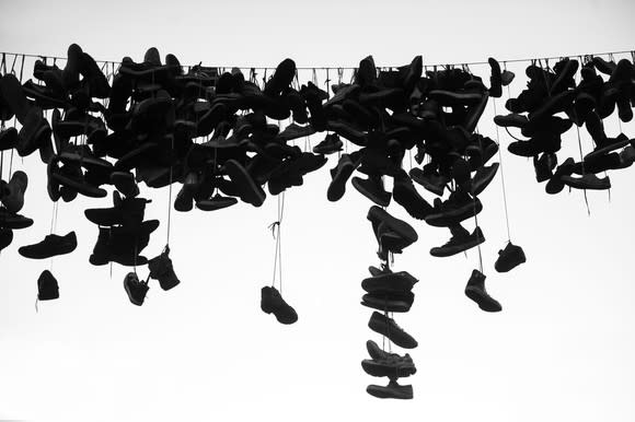 Dozens of shoes hanging from a power line