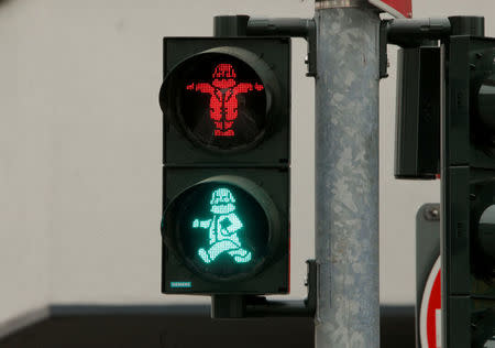 FILE PHOTO: An image of German philosopher Karl Marx is seen in a traffic light for passengers in his hometown in Trier, Germany, April 13, 2018. REUTERS/Wolfgang Rattay/File Photo