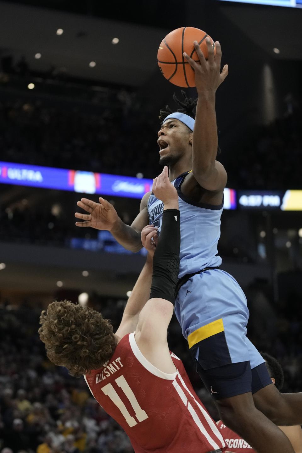 Marquette's Chase Ross is called for a charge on Wisconsin's Max Klesmit during the second half of an NCAA college basketball game Saturday, Dec. 3, 2022, in Milwaukee. Wisconsin won 80-77 in overtime. (AP Photo/Morry Gash)