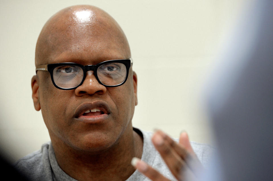 FILE - In this Aug. 26, 2014 file photo, Leon Brown speaks with a reporter at the Maury Correctional Institution in Maury, N.C., about his incarceration. Lawyers representing two former North Carolina sheriff’s deputies agreed on Friday, May 14, 2021, to a $9 million settlement with Brown and his half brother Henry McCollum, who spent decades behind bars after being wrongfully convicted in the 1983 killing of an 11-year-old girl. (Chuck Liddy/The News & Observer via AP, File)