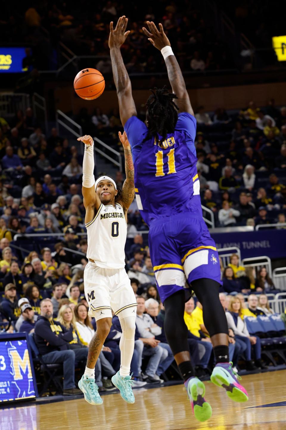 Michigan Wolverines guard Dug McDaniel (0) shoots over McNeese State Cowboys forward CJ Felder (11) in the first half at Crisler Center in Ann Arbor on Friday, Dec. 29, 2023.
